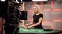 A female dealer that's being live streamed for an online casino.
